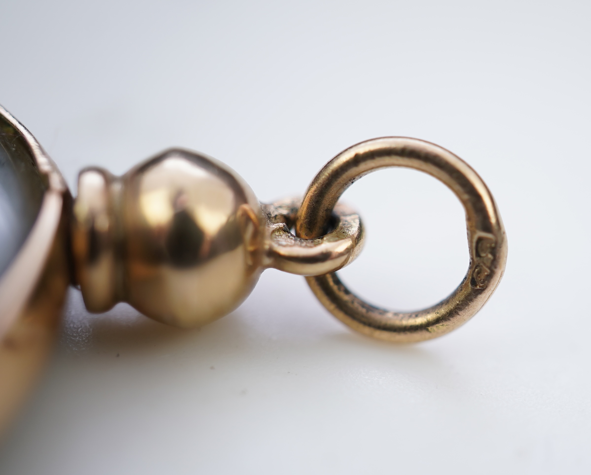 A gold and Roman bronze coin pendant
